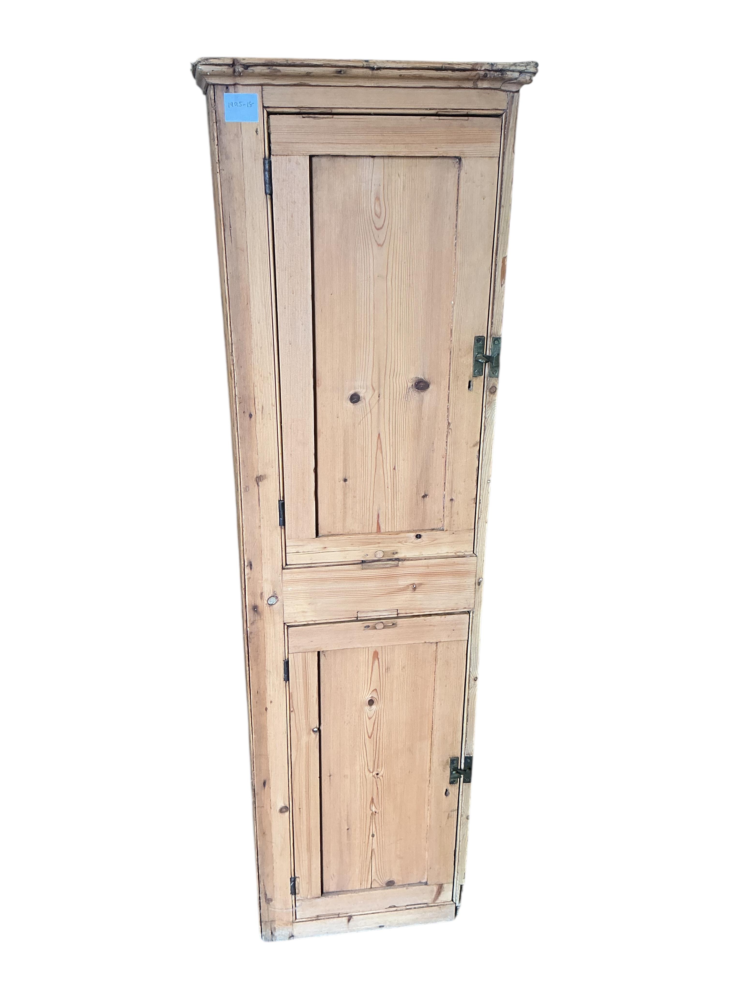 A Victorian pine narrow two door cupboard, width 43cm, depth 26cm, height 148cm